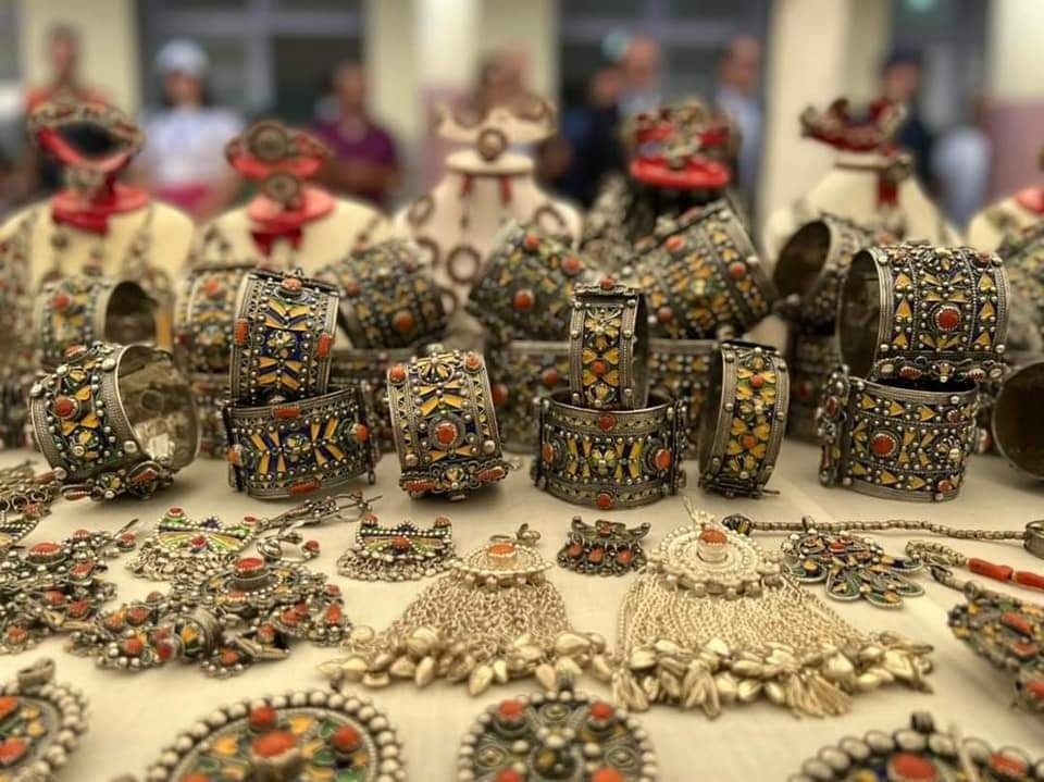 Display of traditional Kabyle silver jewelry decorated with colorful enamel and coral-red details